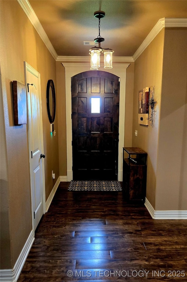 6865 Wilson St, Durant, OK 74701 - entrance foyer with wood finished floors, crown molding, and a chandelier