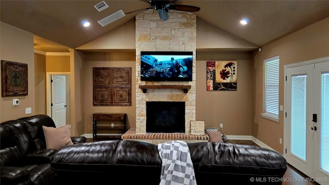 6865 Wilson St, Durant, OK 74701 - living area with a stone fireplace, vaulted ceiling, ceiling fan, recessed lighting, and french doors