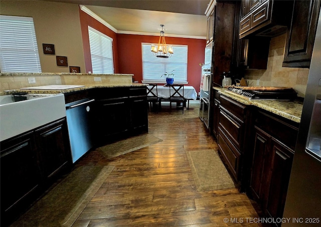 6865 Wilson St, Durant, OK 74701 - kitchen with stainless steel appliances, dark wood-type flooring, ornamental molding, decorative backsplash, and a chandelier