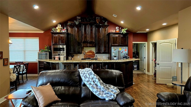 6865 Wilson St, Durant, OK 74701 - kitchen with appliances with stainless steel finishes, dark wood-style floors, a large island, dark brown cabinets, and recessed lighting