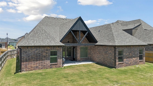 5906 E 126th Pl S, Bixby, OK 74008 - rear view of house with brick siding, a fenced backyard, a patio, a shingled roof, and board and batten siding