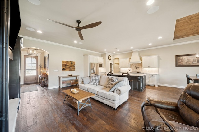 5906 E 126th Pl S, Bixby, OK 74008 - living room featuring arched walkways, ceiling fan, recessed lighting, dark wood-type flooring, and crown molding