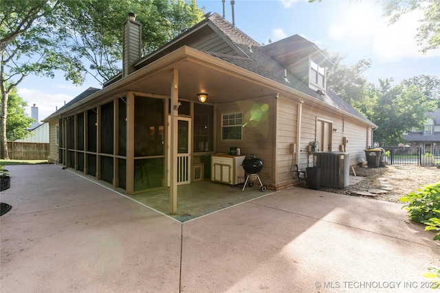 12511 S 18th Cir E, Jenks, OK 74037 - rear view of property with a sunroom, a patio, a chimney, and a shingled roof