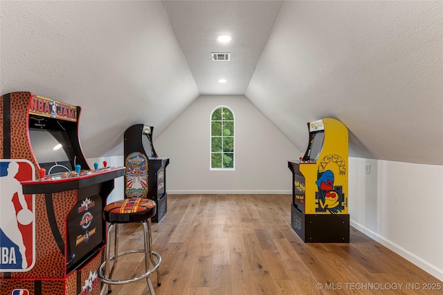 12511 S 18th Cir E, Jenks, OK 74037 - playroom with hardwood / wood-style floors, vaulted ceiling, and a textured ceiling