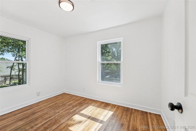 2127 W 48th Pl, Tulsa, OK 74107 - spare room with healthy amount of natural light and wood finished floors