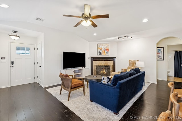 2610 E 5th Pl, Tulsa, OK 74104 - living area with lofted ceiling, arched walkways, ceiling fan, hardwood / wood-style flooring, and a premium fireplace