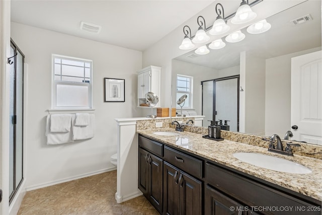 2610 E 5th Pl, Tulsa, OK 74104 - bathroom featuring a shower stall, double vanity, and tile patterned flooring