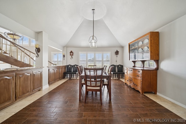 8120 E 112th St, Owasso, OK 74055 - dining room with plenty of natural light, wood finished floors, lofted ceiling, and a chandelier