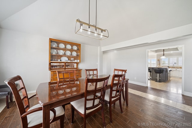 8120 E 112th St, Owasso, OK 74055 - dining area featuring dark wood-style floors and high vaulted ceiling