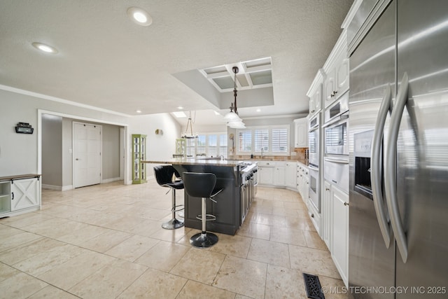 8120 E 112th St, Owasso, OK 74055 - kitchen with stainless steel fridge with ice dispenser, a warming drawer, a kitchen breakfast bar, white cabinetry, and ornamental molding