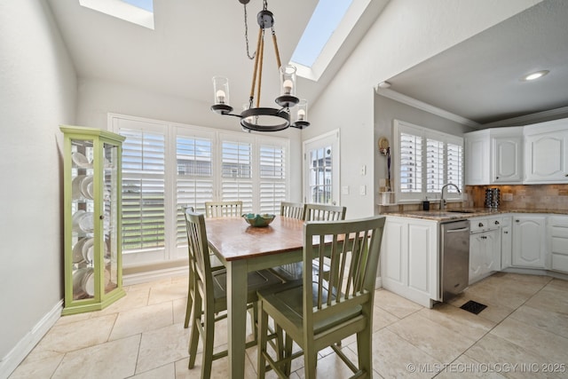8120 E 112th St, Owasso, OK 74055 - dining room with a skylight, a chandelier, light tile patterned floors, vaulted ceiling, and crown molding
