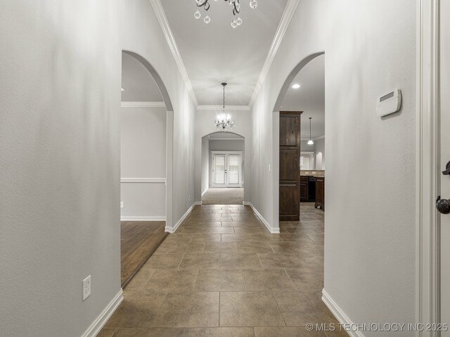 3712 W 107th Ct, Jenks, OK 74037 - entryway with arched walkways, crown molding, a chandelier, and tile patterned floors