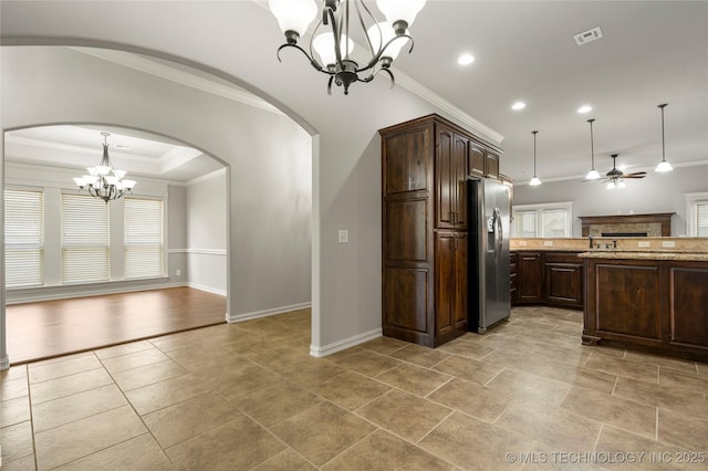 3712 W 107th Ct, Jenks, OK 74037 - kitchen with stainless steel refrigerator with ice dispenser, a chandelier, arched walkways, plenty of natural light, and ornamental molding