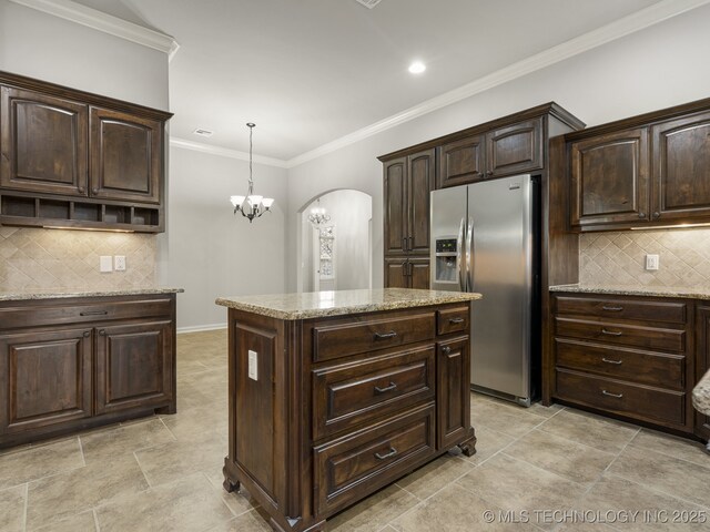 3712 W 107th Ct, Jenks, OK 74037 - kitchen featuring stainless steel fridge with ice dispenser, a center island, backsplash, light stone counters, and crown molding