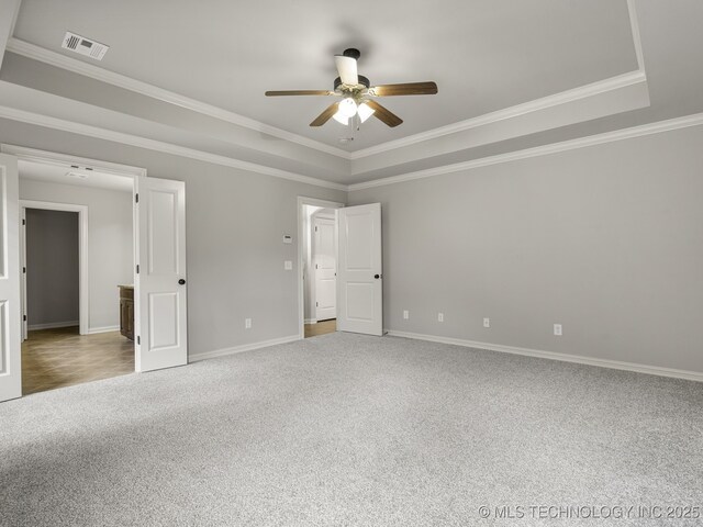 3712 W 107th Ct, Jenks, OK 74037 - unfurnished bedroom featuring a tray ceiling, carpet, ornamental molding, and ceiling fan
