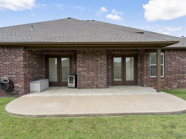 3712 W 107th Ct, Jenks, OK 74037 - back of property featuring french doors, brick siding, and a shingled roof