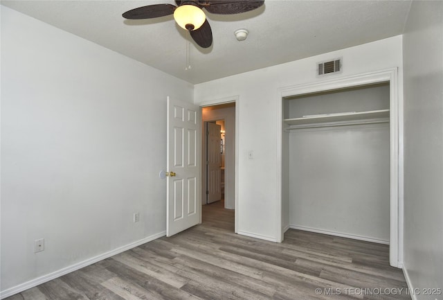 20529 E 4th St, Tulsa, OK 74108 - unfurnished bedroom featuring wood finished floors, a closet, and a ceiling fan