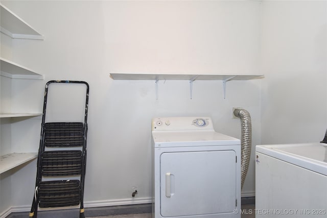 20529 E 4th St, Tulsa, OK 74108 - laundry area with washer and clothes dryer and baseboards