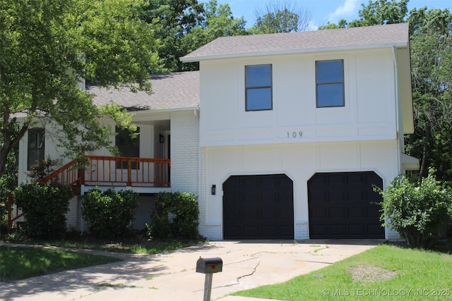 109 E 48th St, Sand Springs, OK 74063 - tri-level home featuring brick siding, roof with shingles, a garage, and driveway