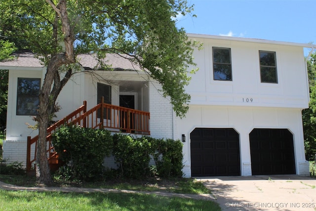 109 E 48th St, Sand Springs, OK 74063 - view of front of home with brick siding, an attached garage, and driveway