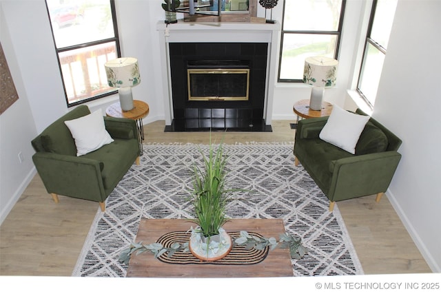 109 E 48th St, Sand Springs, OK 74063 - living area featuring wood finished floors and a tile fireplace