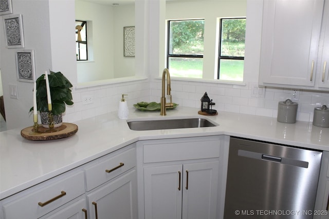 109 E 48th St, Sand Springs, OK 74063 - kitchen featuring dishwasher, decorative backsplash, light countertops, and white cabinetry