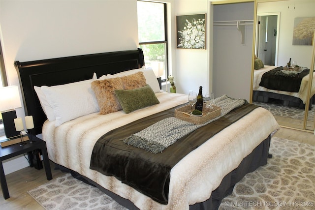 109 E 48th St, Sand Springs, OK 74063 - bedroom featuring wood finished floors and a closet