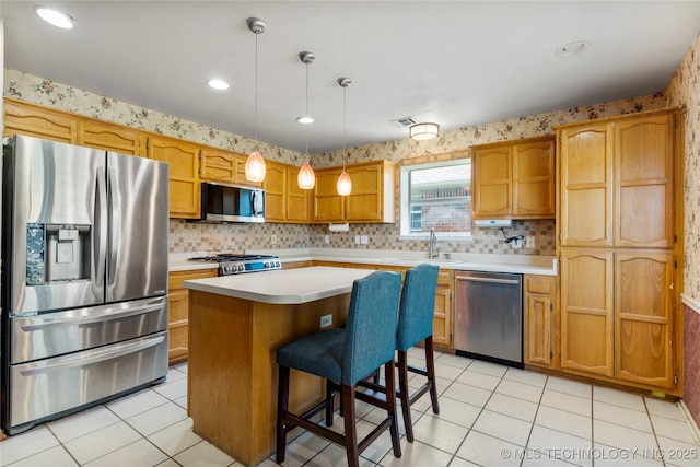 3220 N 3rd Pl, Broken Arrow, OK 74012 - kitchen featuring stainless steel appliances, light countertops, light tile patterned floors, a kitchen island, and recessed lighting