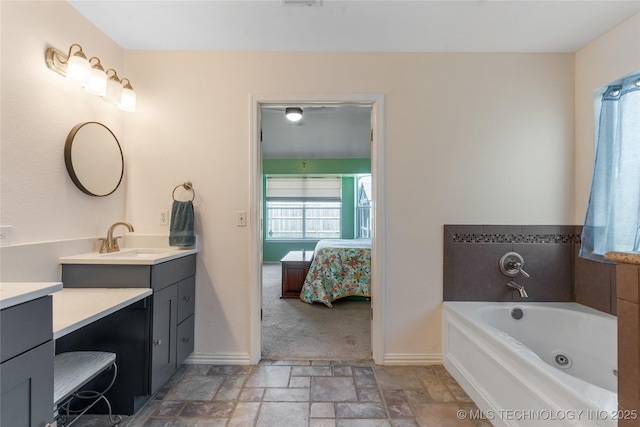 3220 N 3rd Pl, Broken Arrow, OK 74012 - full bathroom with vanity, connected bathroom, a whirlpool tub, and stone finish floors