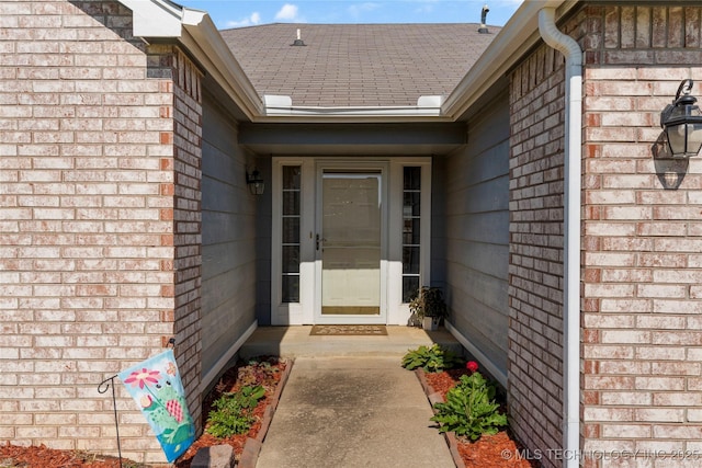 3220 N 3rd Pl, Broken Arrow, OK 74012 - view of exterior entry with brick siding and roof with shingles