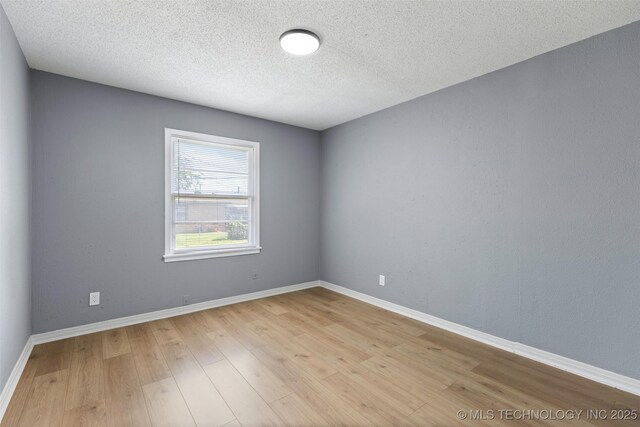 10942 E 4th Pl N, Tulsa, OK 74128 - empty room featuring light wood finished floors and a textured ceiling