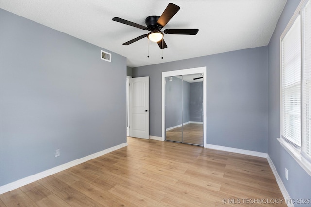 10942 E 4th Pl N, Tulsa, OK 74128 - unfurnished bedroom with light wood-style floors, a closet, and ceiling fan