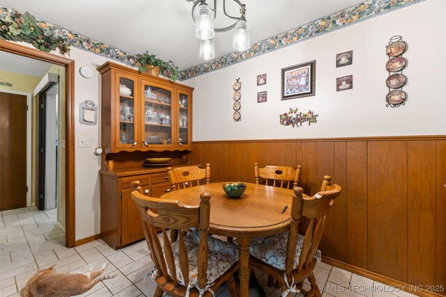3811 Broadway Ct, Ada, OK 74820 - dining area with a wainscoted wall and wooden walls