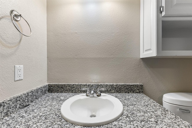 1505 Augusta, Ada, OK 74820 - bathroom featuring a textured wall and vanity