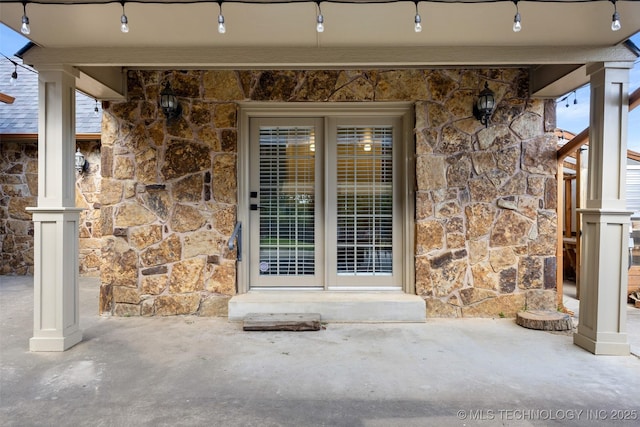 1505 Augusta, Ada, OK 74820 - doorway to property featuring stone siding
