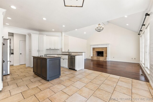 1505 Augusta, Ada, OK 74820 - kitchen featuring stainless steel appliances, white cabinets, open floor plan, a kitchen island, and recessed lighting