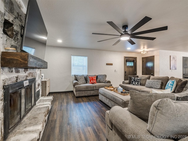 11 Port Duncan, Afton, OK 74331 - living area with dark wood-type flooring, a stone fireplace, a ceiling fan, and recessed lighting