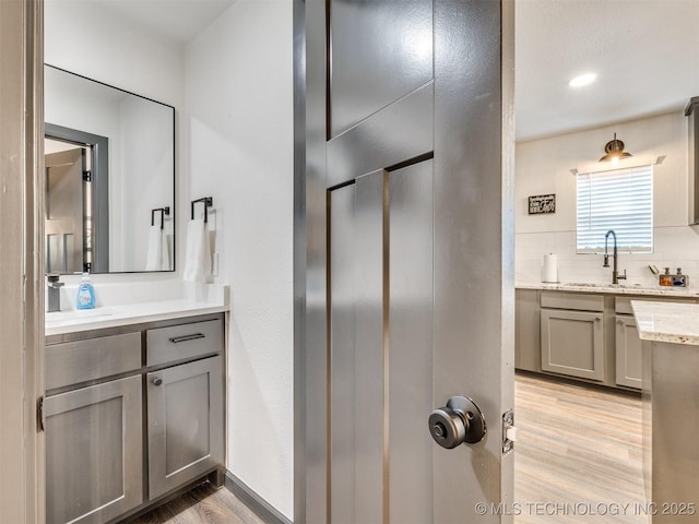 11 Port Duncan, Afton, OK 74331 - full bathroom with wood finished floors, vanity, and tasteful backsplash