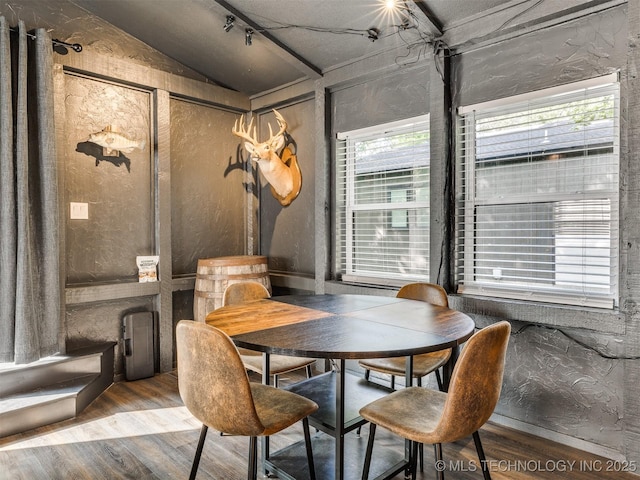 11 Port Duncan, Afton, OK 74331 - dining space featuring wood finished floors, lofted ceiling, and a textured wall