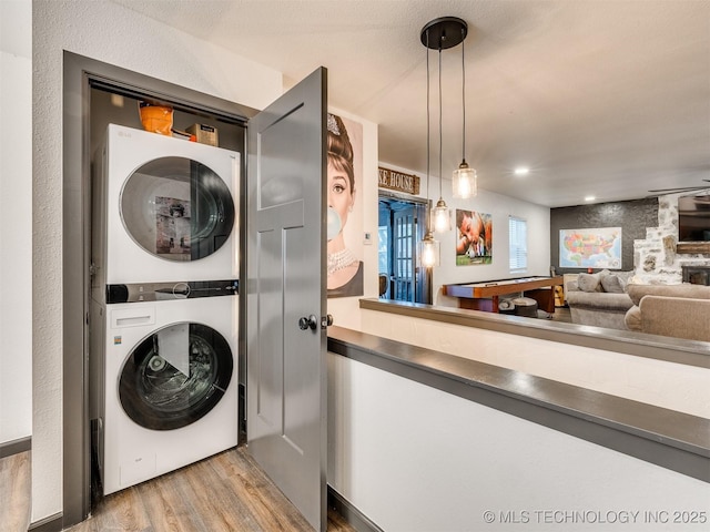 11 Port Duncan, Afton, OK 74331 - laundry area featuring stacked washer and clothes dryer and wood finished floors