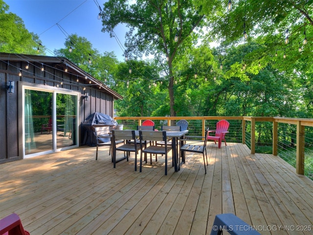11 Port Duncan, Afton, OK 74331 - wooden deck with outdoor dining space and view of scattered trees