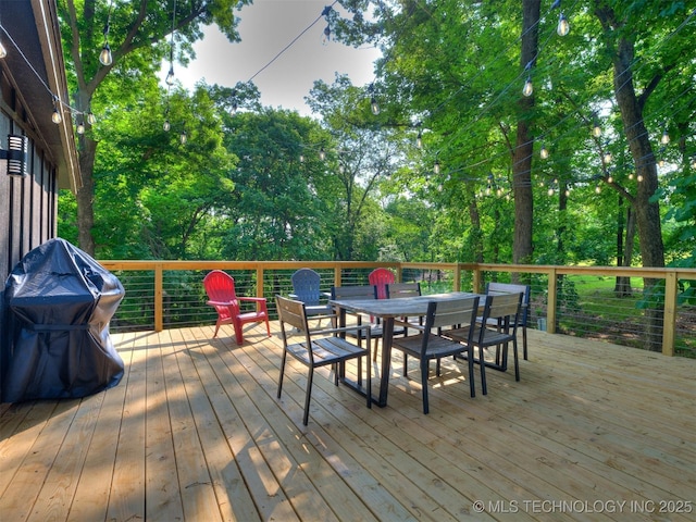 11 Port Duncan, Afton, OK 74331 - deck featuring outdoor dining area and view of wooded area