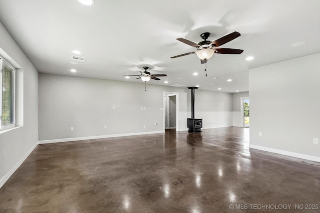 36619 W 141st St S, Bristow, OK 74010 - unfurnished living room featuring a wood stove, concrete floors, recessed lighting, and ceiling fan