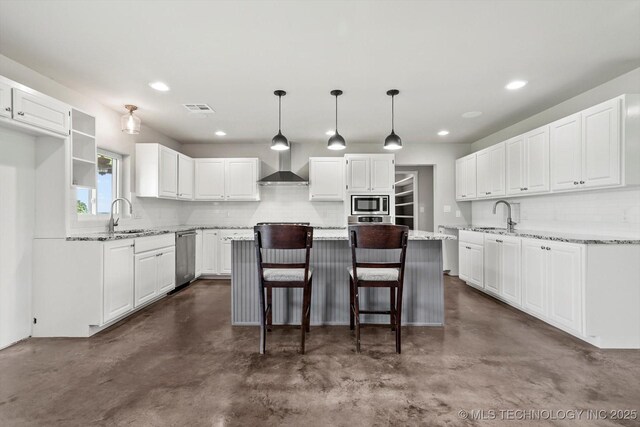 36619 W 141st St S, Bristow, OK 74010 - kitchen featuring wall chimney range hood, finished concrete flooring, a center island, decorative backsplash, and appliances with stainless steel finishes