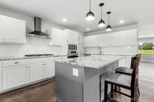 36619 W 141st St S, Bristow, OK 74010 - kitchen featuring wall chimney exhaust hood, appliances with stainless steel finishes, backsplash, white cabinets, and a kitchen breakfast bar