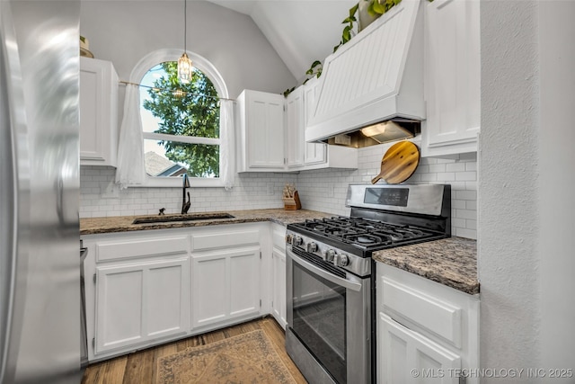 19912 E 36th St S, Broken Arrow, OK 74014 - kitchen featuring stainless steel gas stove, fridge, custom range hood, lofted ceiling, and dark wood-type flooring