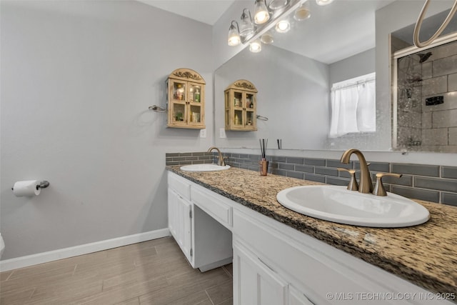 19912 E 36th St S, Broken Arrow, OK 74014 - bathroom featuring backsplash, double vanity, tiled shower, and wood finished floors