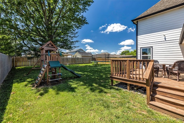 19912 E 36th St S, Broken Arrow, OK 74014 - fenced backyard featuring a trampoline, a playground, and a deck