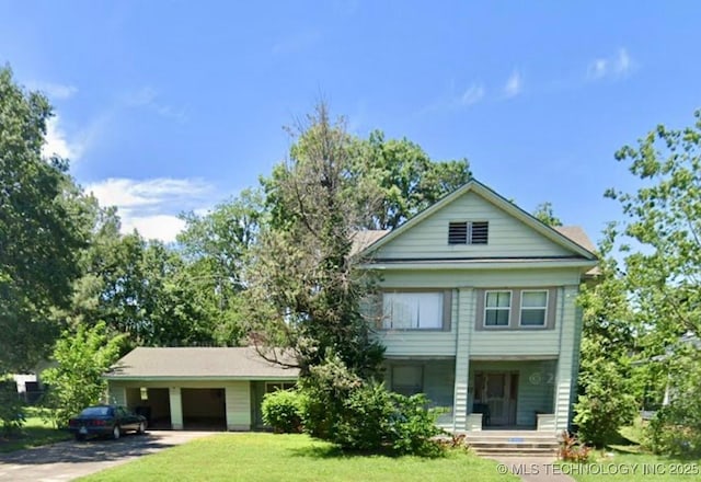 519 N 15th St, Muskogee, OK 74401 - view of front of house with a front lawn, a garage, covered porch, and driveway