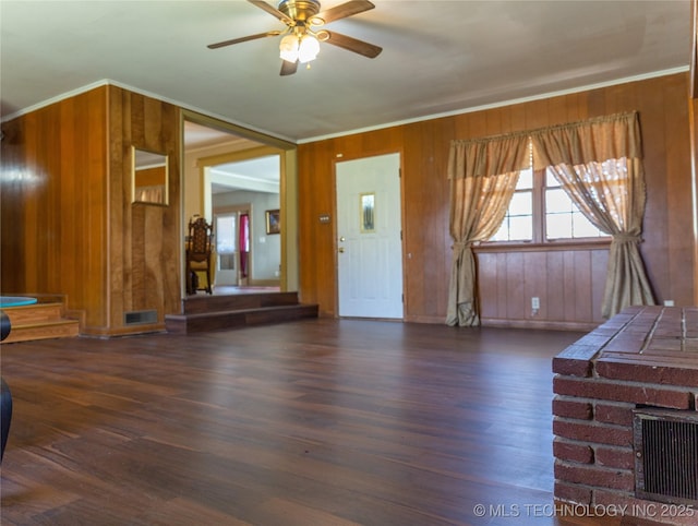 519 N 15th St, Muskogee, OK 74401 - unfurnished living room with wooden walls, a ceiling fan, wood finished floors, and crown molding